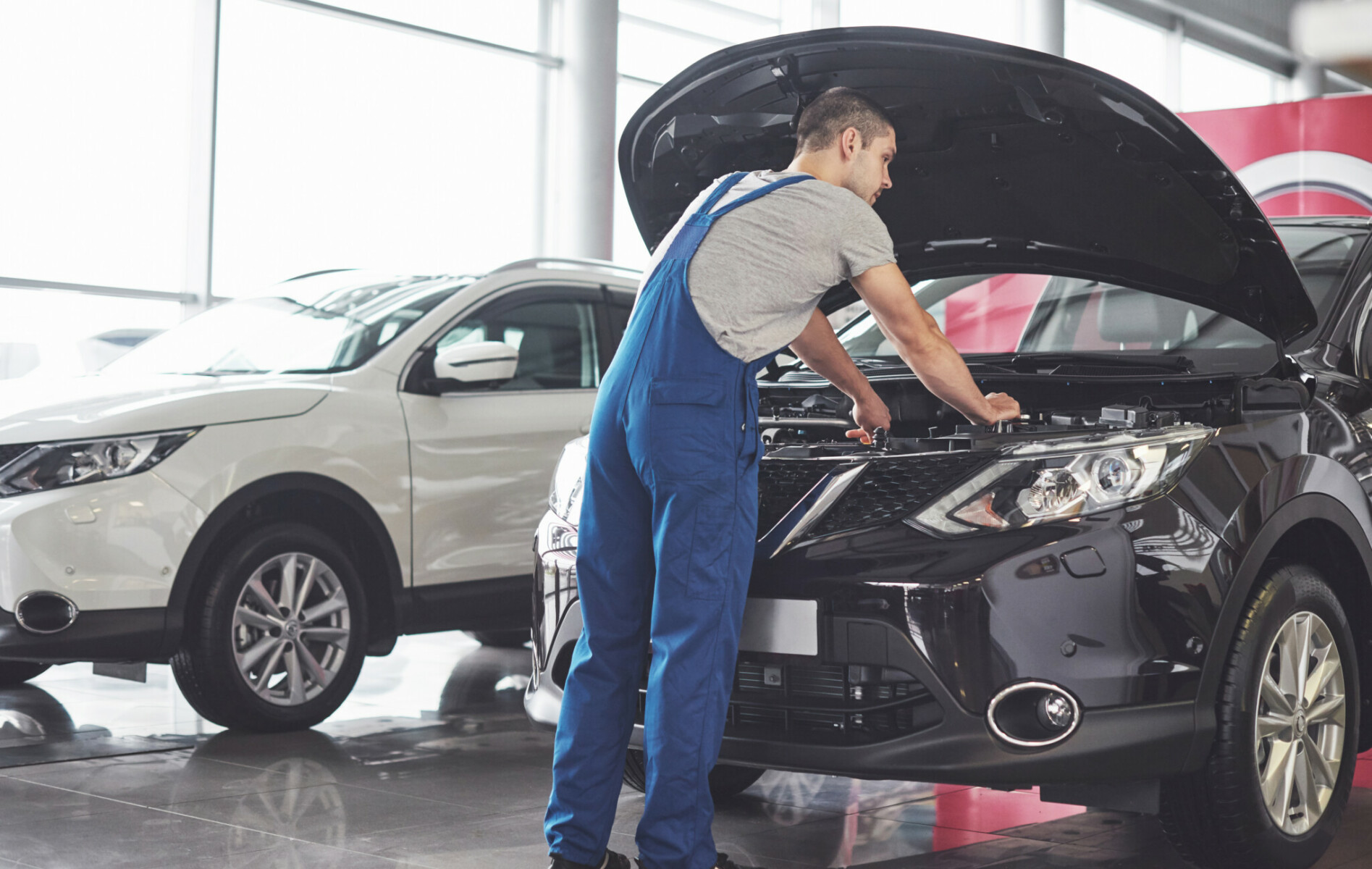 Picture Showing Muscular Car Service Worker Repairing Vehicle